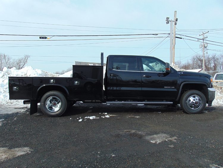 Black truck with gooseneck on snowy background