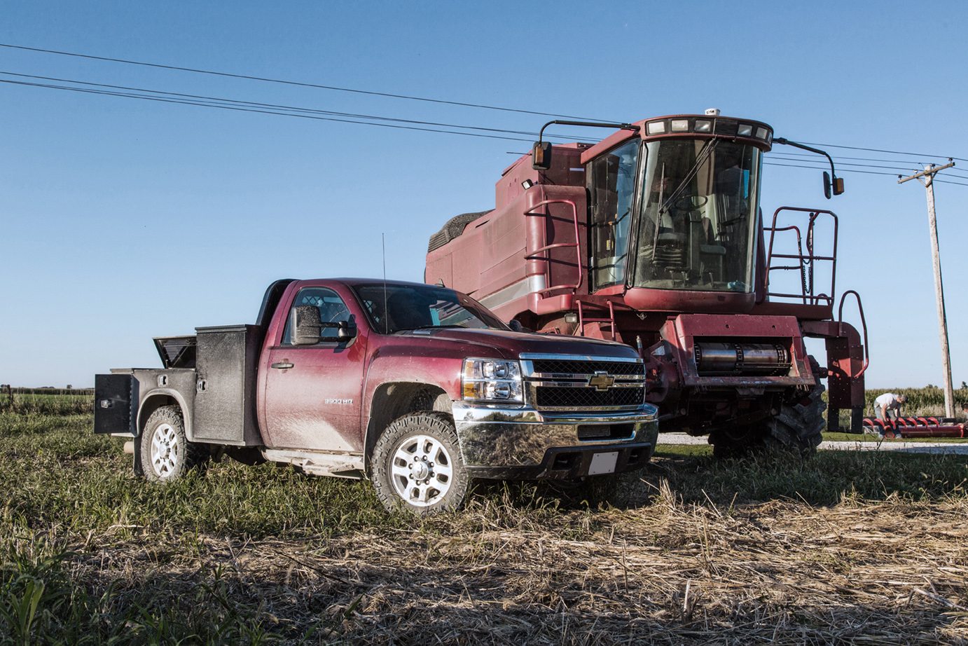 Dark red truck with gooseneck on farm background